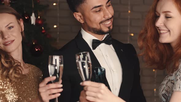 Mixed Race Friends Clinking at Holiday Party in New Year