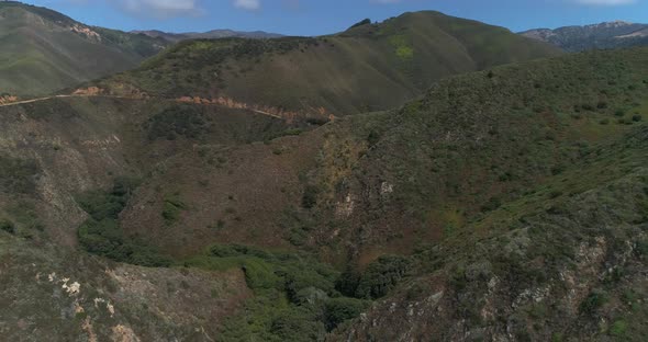 Aerial Drone Stock Video of Bixby Bridge Highway with water and shore below in Big Sur Monterrey Cal