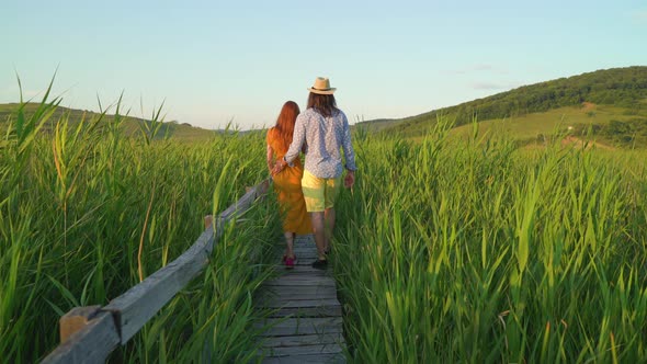 Couple walking in a reed field