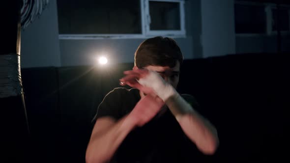 Alone Boxer Improves Boxing Movements in Dark Gym in Slow Motion