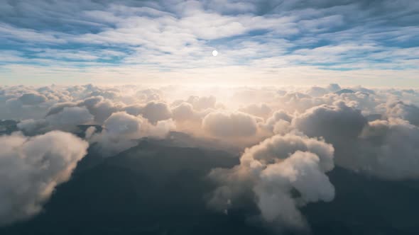 View of clouds over the mountains from a cockpit of a plane