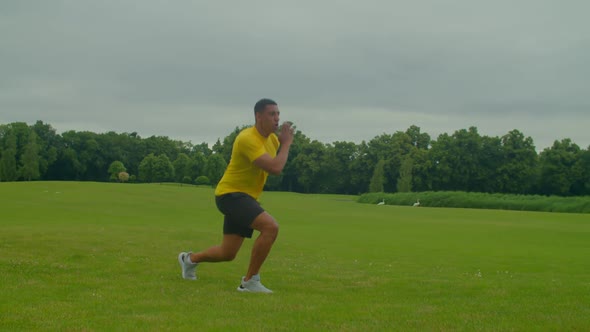 Determined Fit African Man Practicing Plyometric Jumping Lunges Outdoors