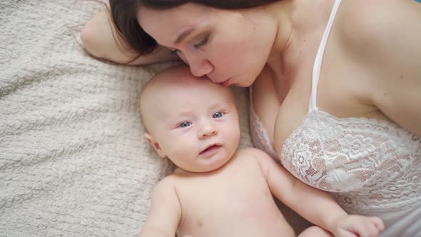 a Mother and the Baby on the Bed