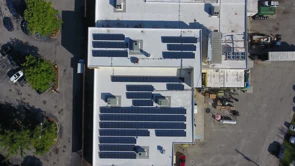 Solar panels on the roof of modern factory industrial warehouse. Clean renewable electrical energy