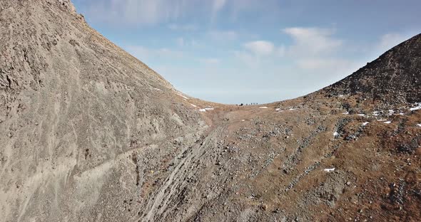 A Group of Tourists Stands on the Mountainside