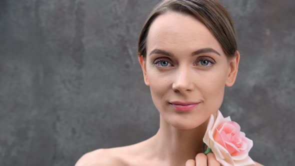 Closeup Portrait Pleasant Girl Stroking Fresh Skin By Pink Flower