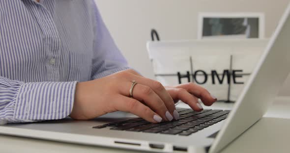 Close up female hands typing on laptop. Freelance home office. Making project. 