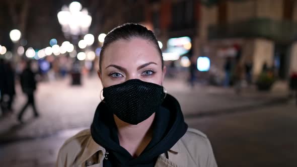 Portrait of Woman in Facial Protective Mask on Night City Street with Illumination