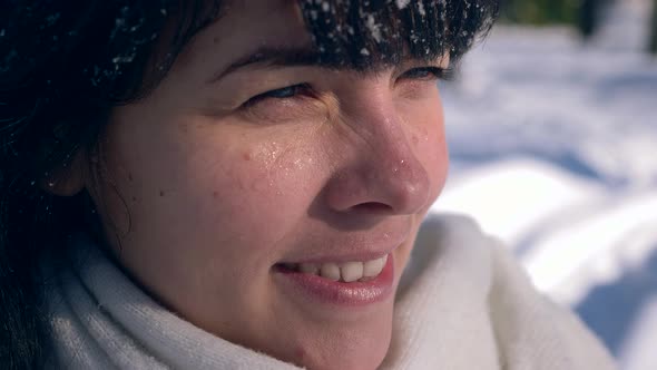 Close-up Pretty Female Face. Snowflakes On Hair. Young Adult In Snow Covered