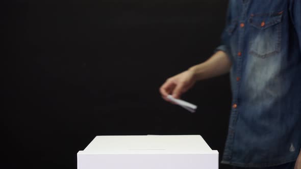 People Holding Ballot Paper Casting Vote at a Polling Station for Election Vote in Black Background