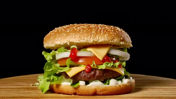 Cheeseburger with Bacon on a Dark Background. Close-up. Macro Shooting