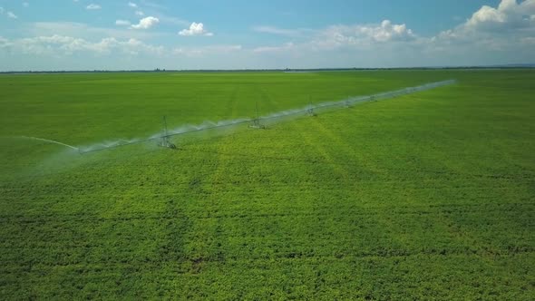 Picturesque Aerial Landscape of Green Field with Irrigation System, Watering Plants