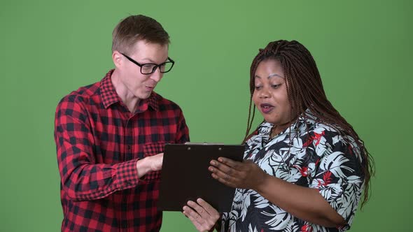 Overweight African Woman and Young Scandinavian Man Together Against Green Background