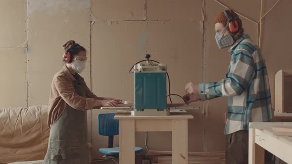 Two Carpenters Working Together in Workshop