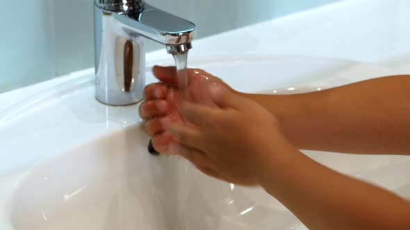 The child washes his hands with soap under the sweat of water. Clean hand concept idea.