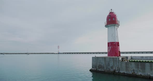 View on Lighthouse with Red and White Stripes From Moving Boat