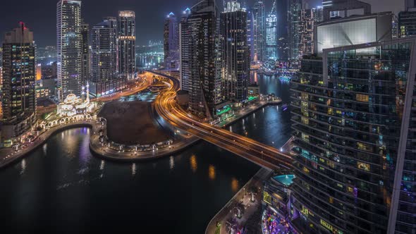 Aerial View of Dubai Marina Residential and Office Skyscrapers with Waterfront Night Timelapse