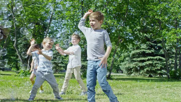 Group of Kids Bursting Soap Bubbles