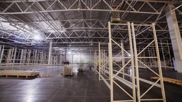 Employees Assemble Racks of Metal Parts in Plant Warehouse