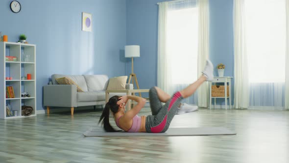 Young Woman Is Doing Bicycle Crunches