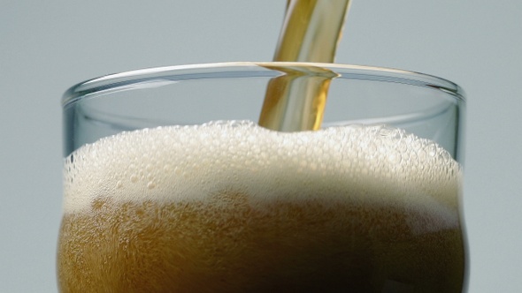 Beer Pours Into Glass Closeup