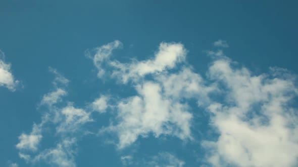 White clouds fly across a bright blue sky, Cloud time lapse