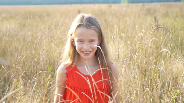 Beautiful Little Blonde Girl, Has Happy Fun Cheerful Smiling Face, Red Dress