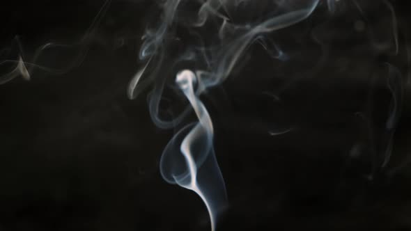 White stream of smoke on black background. Beautiful wobble. Close up.