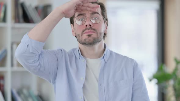 Portrait of Man in Glasses Looking Around Searching