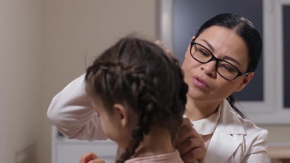 Woman Otolaryngologist Examining Sick Girl's Ears