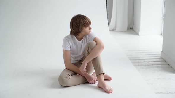 Teen Boy in White Tshirt Pose in a Photo Studio