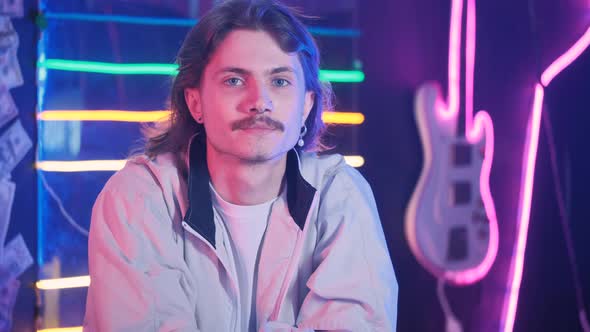 Portrait of Millennial Man with Long Hair in Neon Retro Style