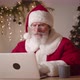 Upset Frustrated Mature Man with Gray Beard in Santa Claus Carnival Costume Looking at Laptop - VideoHive Item for Sale