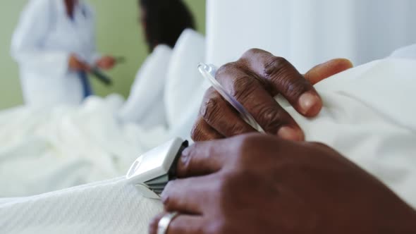 Close-up of pulse oximetry on African american male patient hand in the ward at hospital