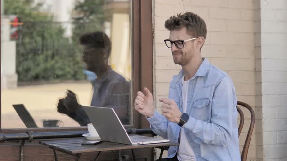 Upset Young Man Using Laptop, Sitting Outdoor