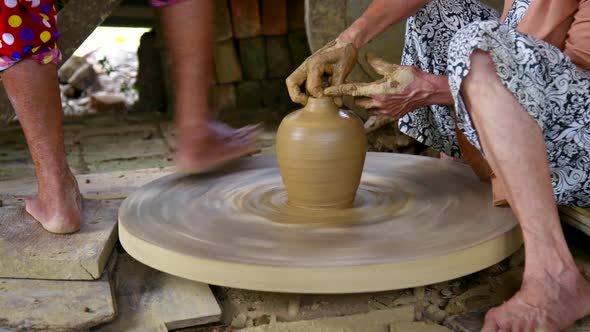 Women Potters Rotate Wheel and Make Beautiful Clay Pot