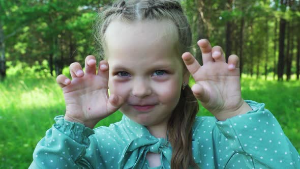 Little Girl Grimaces in Front of the Camera