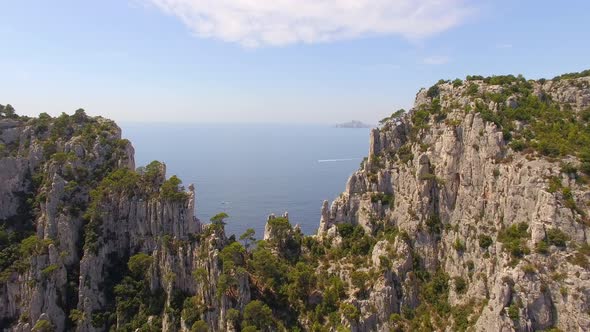 Aerial travel drone view of clear green water, cliffs of Cassis, Mediterranean Sea, Southern France.