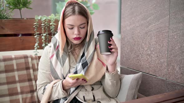 woman is chatting on the phone and drinking coffee