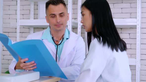 Doctor in Professional Uniform Examining Patient at Hospital