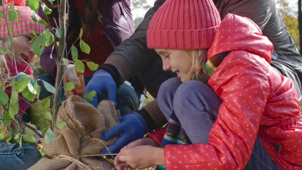 Family of Four with Tree Sapling