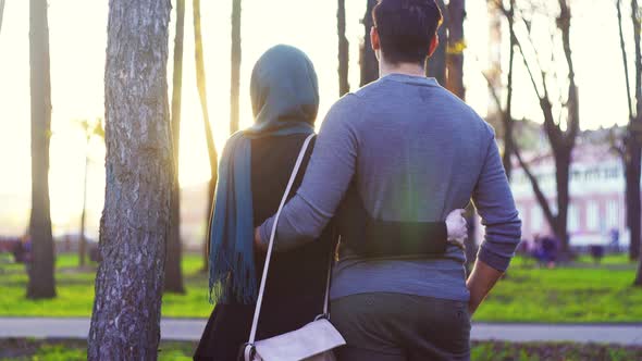 Man and Woman in Hijab Hugging in the Park