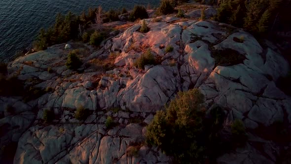 Small White Tent on Rocky Island in Blue Lake, Epic Drone Dolly Out Reveal. Aerial Wide Pedestal Up.