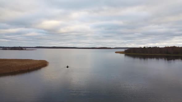 Aerial view of a fisherman on a boat on the lake