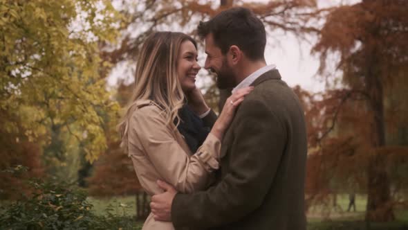 Handsome young couple walking in the autumn park