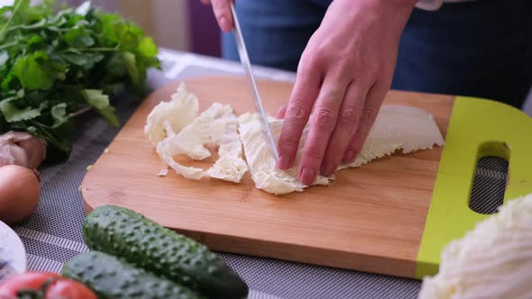 Closeup of Woman Slicing Salad on Wooden Cutting Board  Preparing Ingredient for Meal