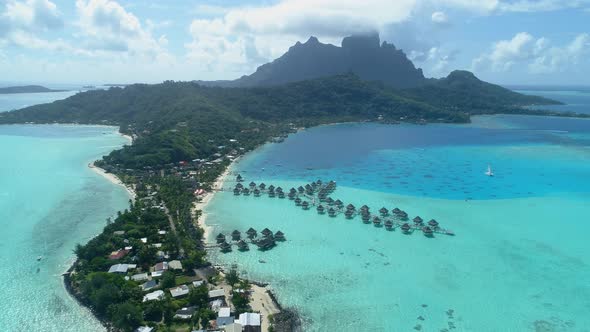 Aerial drone view of a luxury resort and overwater bungalows in Bora Bora tropical island