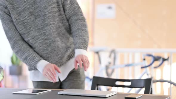 Young Man Coming Back Opening Laptop