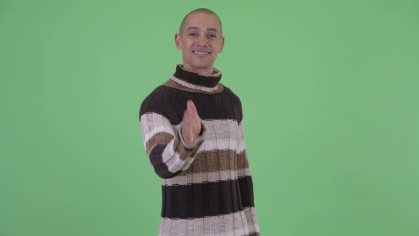 Happy Bald Multi Ethnic Man Giving Handshake Ready for Winter