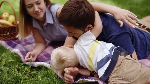 Caucasian Couple Have a Good Time Oudoors with Their Son